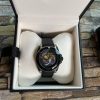 Steel case, black dial with silver feline head motif, black rubber strap ETA quartz movement Water resistance: 20 ATM (660 feet/200 metres) Wrist size adjustable from 161mm to 203mm YA136320 Swiss Made and two year international warranty